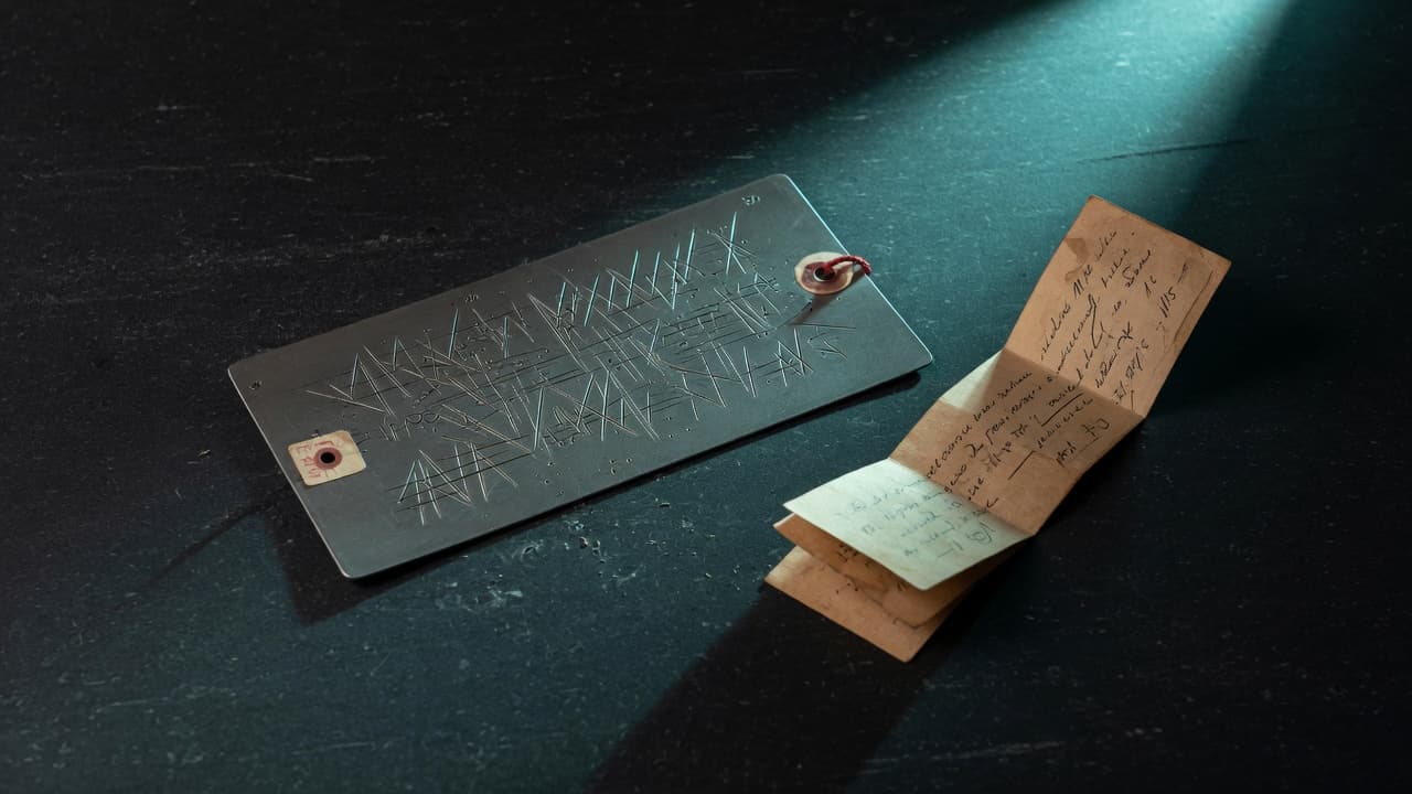 Etched metal evidence plate and an archival strip under a teal work light.